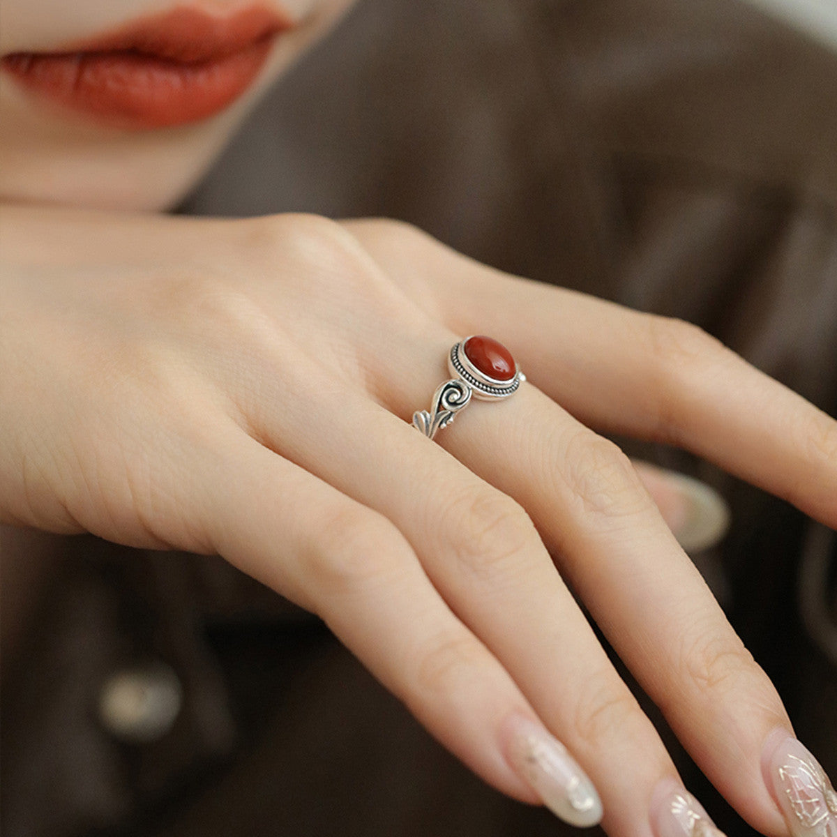 Egg-shaped red and green stone ring