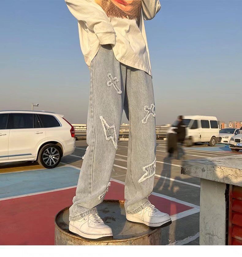 Cross patchwork jeans with frayed hem.