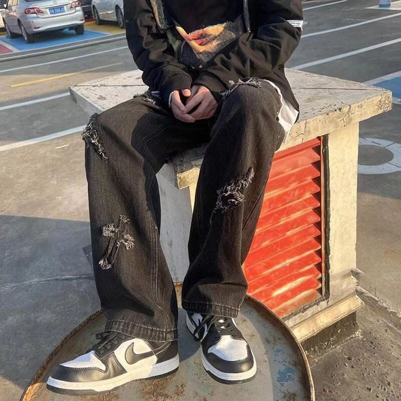 Cross patchwork jeans with frayed hem.