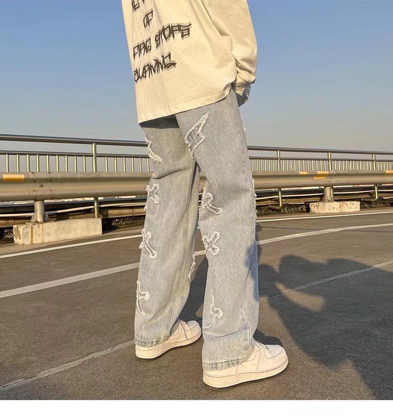 Cross patchwork jeans with frayed hem.