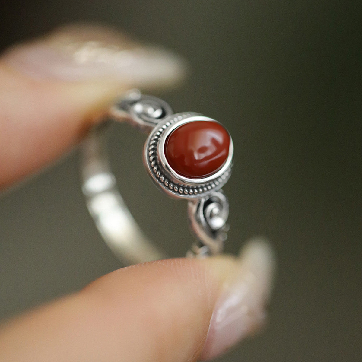 Egg-shaped red and green stone ring