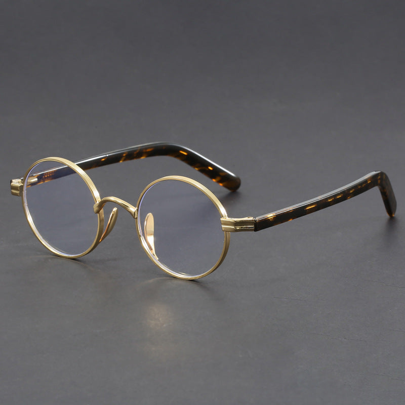 Small round gold-rimmed eyeglasses