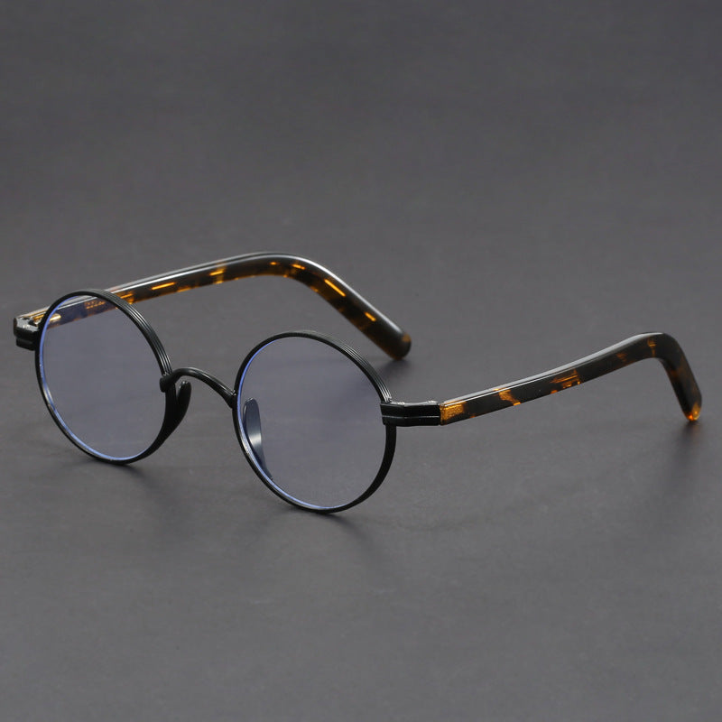 Small round gold-rimmed eyeglasses