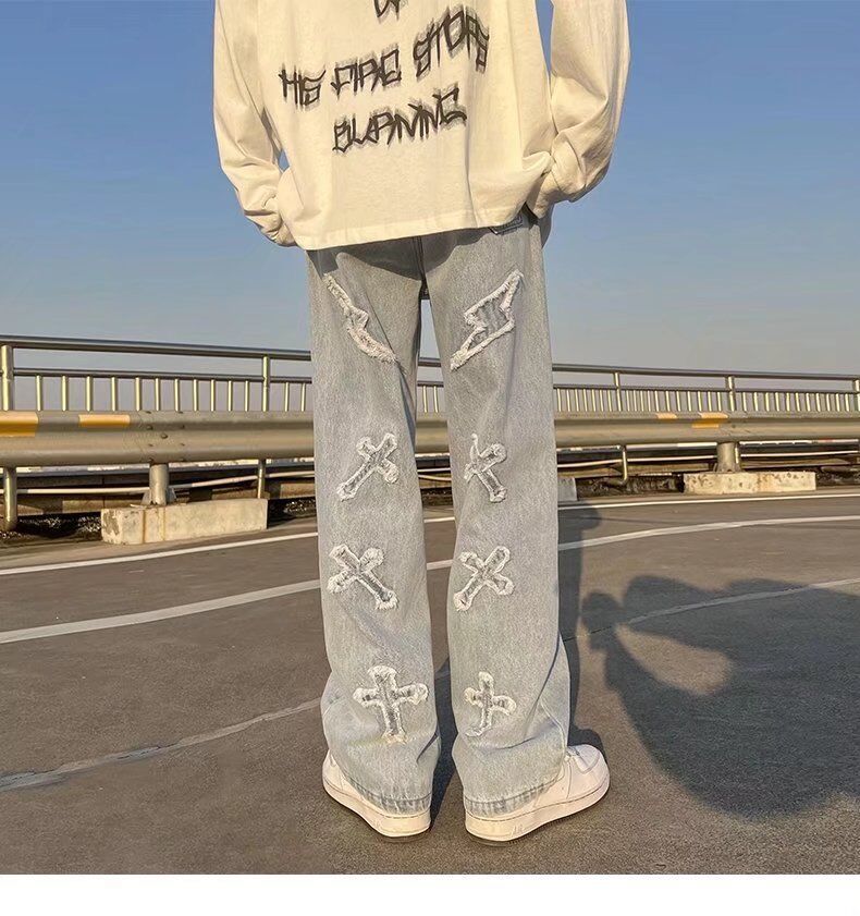 Cross patchwork jeans with frayed hem.