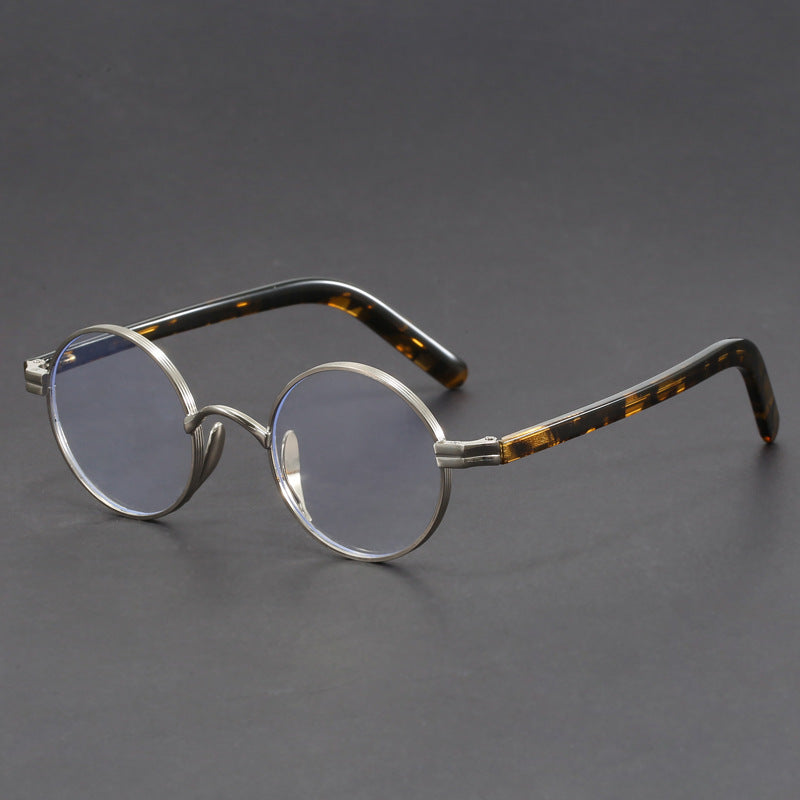 Small round gold-rimmed eyeglasses