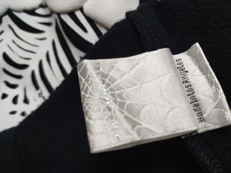 Sp5der fleece-lined hoodie with spiderweb print.