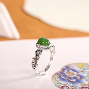 Egg-shaped red and green stone ring